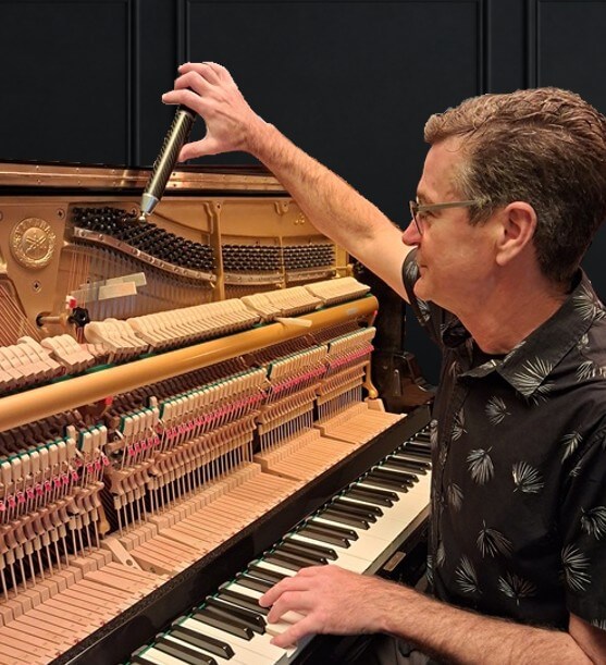 Kevin tuning an upright piano